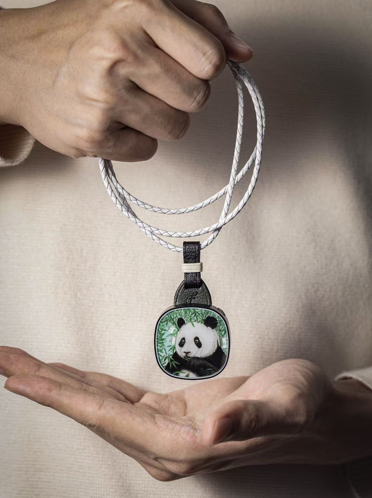 FA001 Manman Panda pendant held by hand